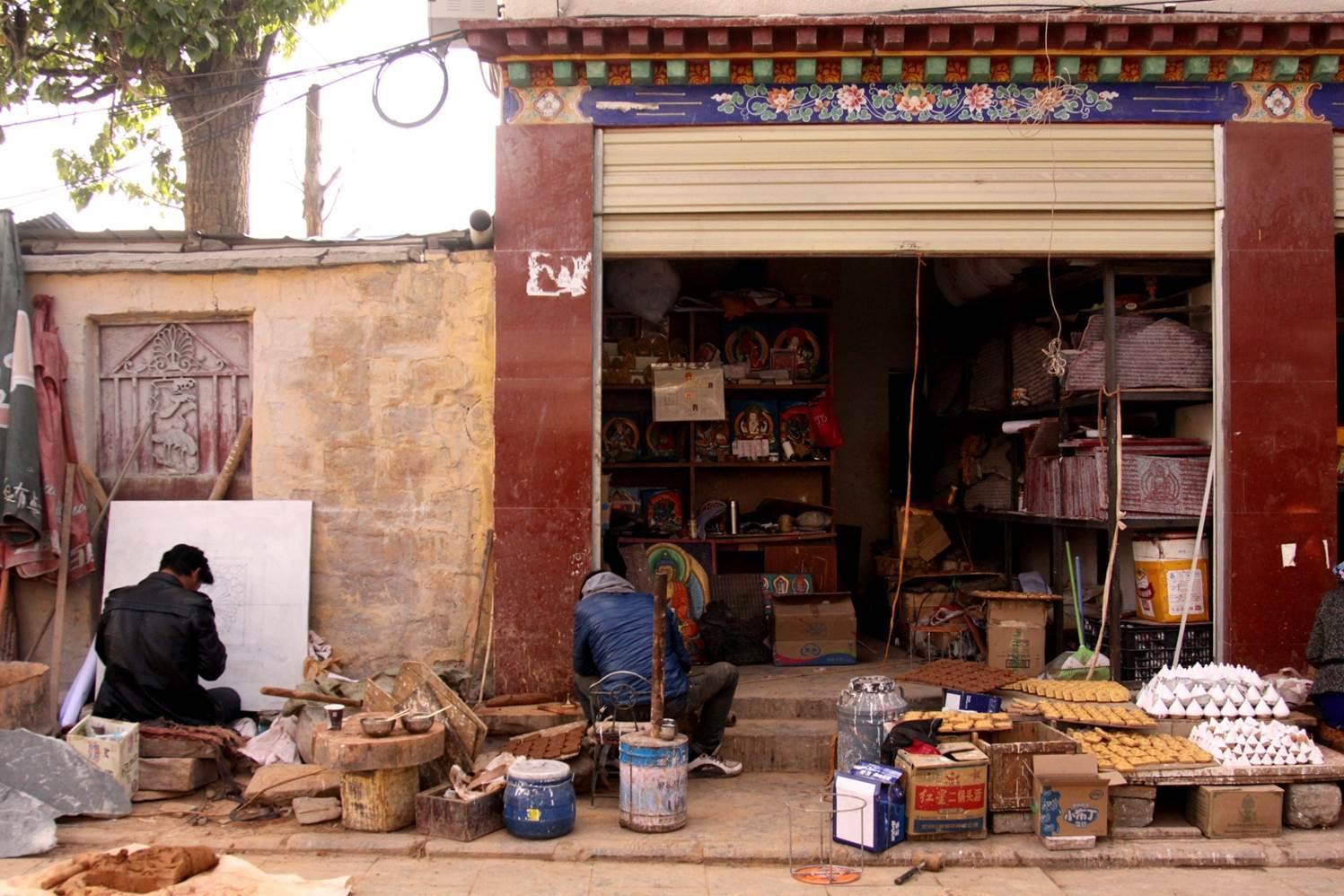 Phuntsog Drapa, owner of a store along the path to Mt. Chakpori,begins his business.