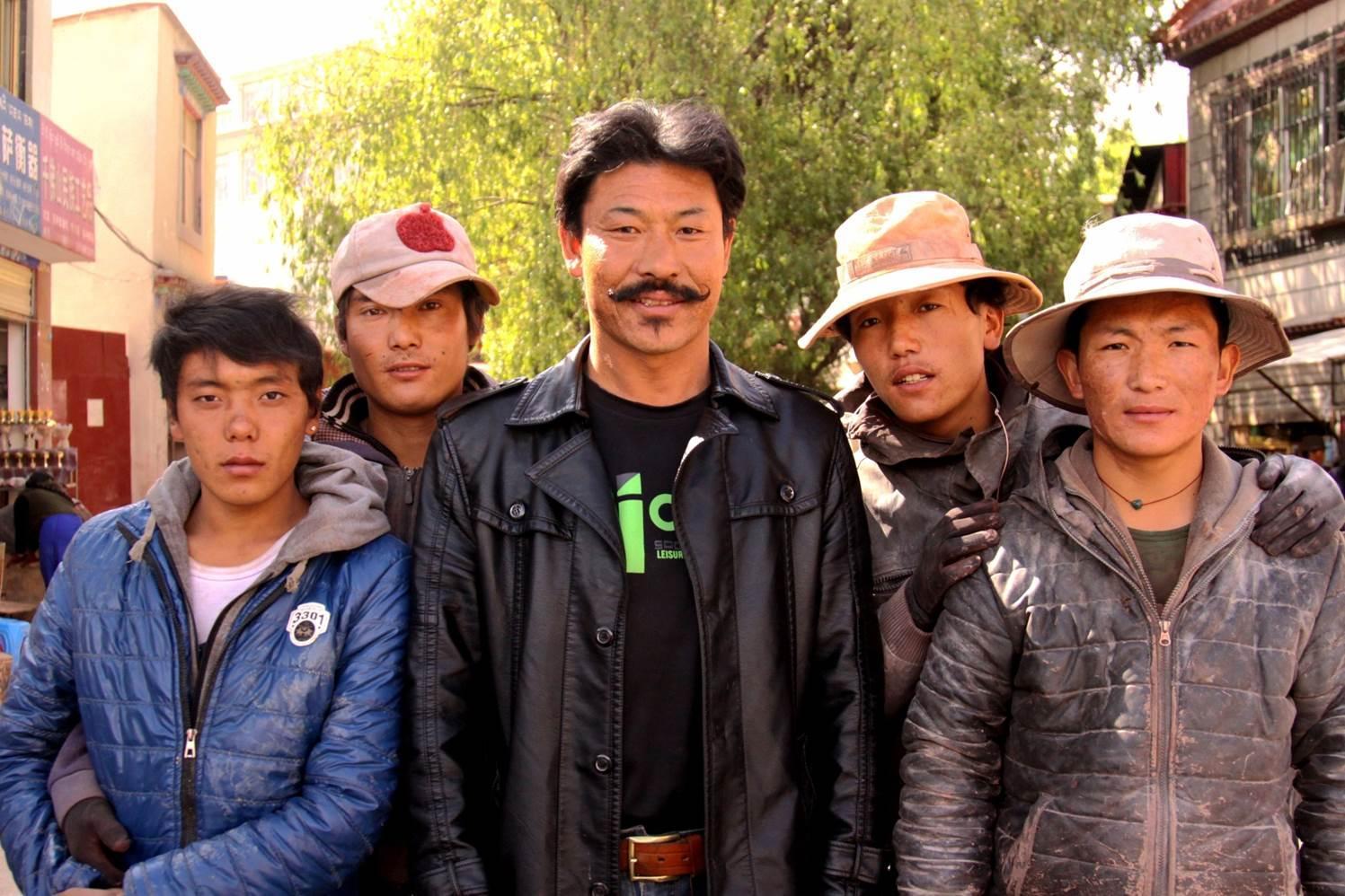 Puntsog Drapa(middle) and his apprentices will show us how to carve a piece of mani stone today.