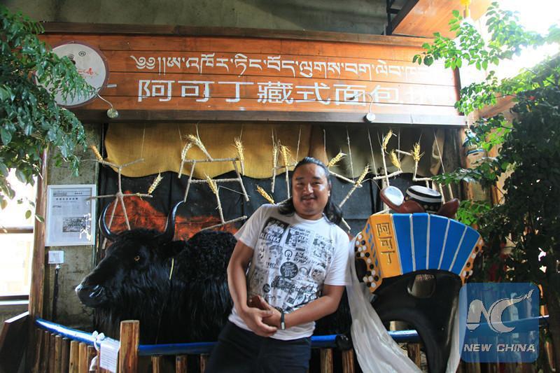 Pasang Tsering stand at his Accordion restaurant along the Lhasa river. [Photo/New China]