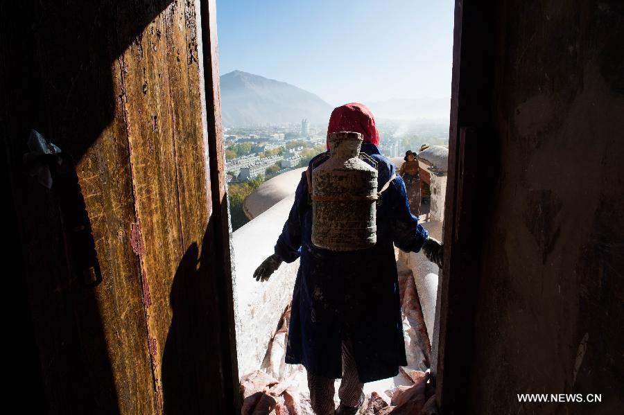 Workers repaint the Potala Palace during an annual renovation of the magnificent ancient architectural complex in Lhasa, capital of southwest China