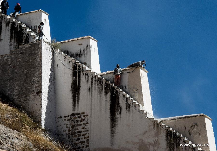 Workers repaint the Potala Palace during an annual renovation of the magnificent ancient architectural complex in Lhasa, capital of southwest China