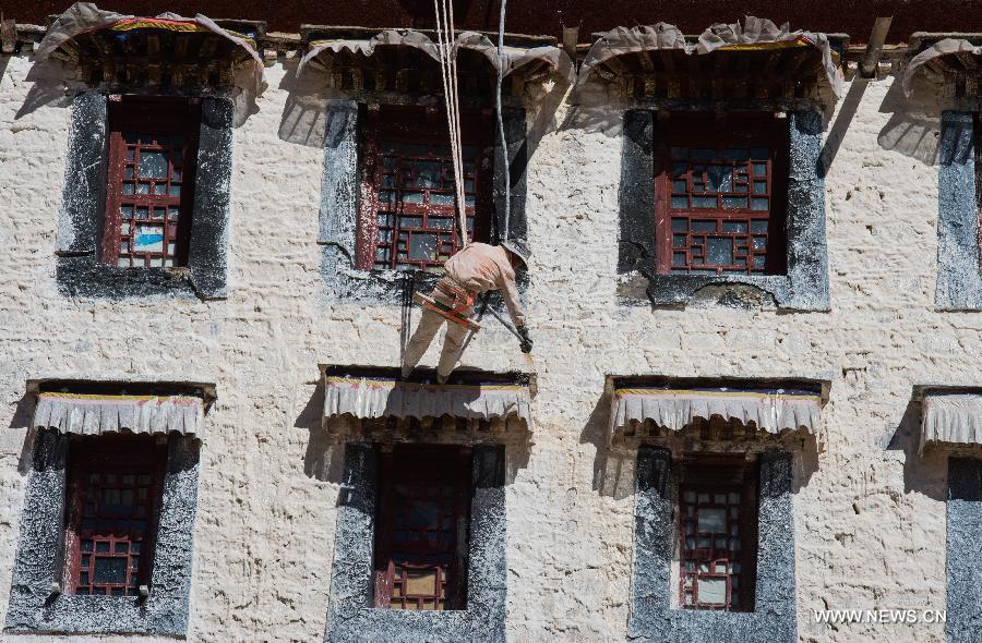 Workers repaint the Potala Palace during an annual renovation of the magnificent ancient architectural complex in Lhasa, capital of southwest China
