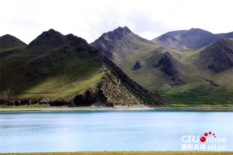 Yamdrok Lake (also known as Yamdrok Yumtso) is a freshwater lake in Tibet, it is one of the three largest sacred lakes in Tibet. It is over 72 km (45 mi) long. The lake is surrounded by many snow-capped mountains and is fed by numerous small streams. The lake has an outlet stream at its far western end. Around 90 km to the west of the lake lies the Tibetan town of Gyantse and Lhasa is a hundred km to the northeast. According to local mythology, Yamdok Yumtso lake is the transformation of a goddess. The lake is revered as a talisman and is said to be part of the life-spirit of Tibet.