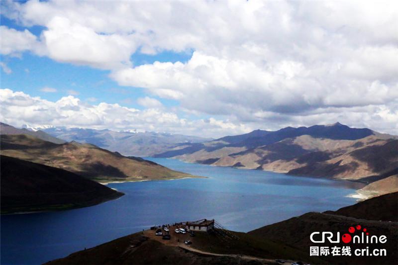 Yamdrok Lake (also known as Yamdrok Yumtso) is a freshwater lake in Tibet, it is one of the three largest sacred lakes in Tibet. It is over 72 km (45 mi) long. The lake is surrounded by many snow-capped mountains and is fed by numerous small streams. The lake has an outlet stream at its far western end. Around 90 km to the west of the lake lies the Tibetan town of Gyantse and Lhasa is a hundred km to the northeast. According to local mythology, Yamdok Yumtso lake is the transformation of a goddess. The lake is revered as a talisman and is said to be part of the life-spirit of Tibet.