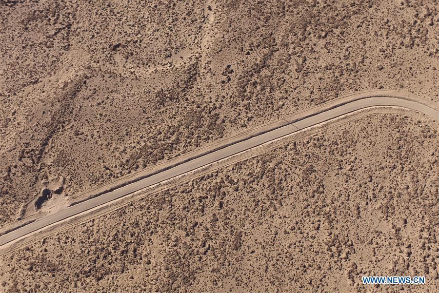 Aerial photo taken on Nov. 18, 2015 shows a road crossing through a desertification recovery area in Tingri County, southwest China