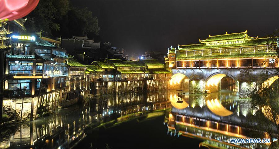 Photo taken on Nov. 29, 2015 shows the night view of the ancient town of Fenghuang in Xiangxi Tujia-Miao Autonomous Prefecture, central China