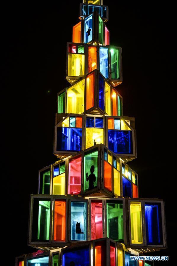 An unusual Christmas tree built by local vocational school students from used wooden window frames is lightened up in Rakvere, Estonia, Nov. 29, 2015. (Xinhua/Sergei Stepanov)