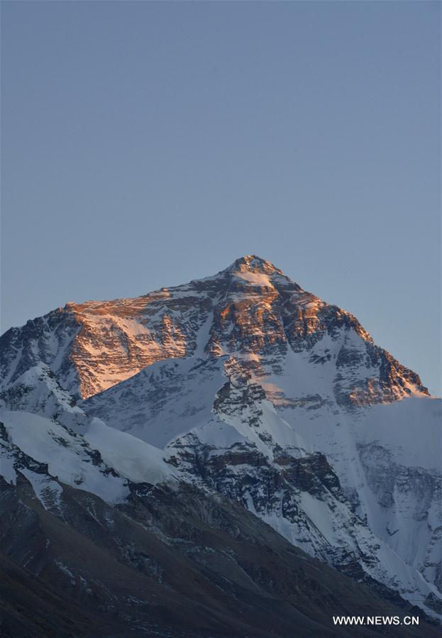 Photo taken on Nov. 19, 2015 shows a distant view of Mount Qomolangma at sunset, the highest peak in the world which stands at an altitude of 8844.43 meters, in southwest China