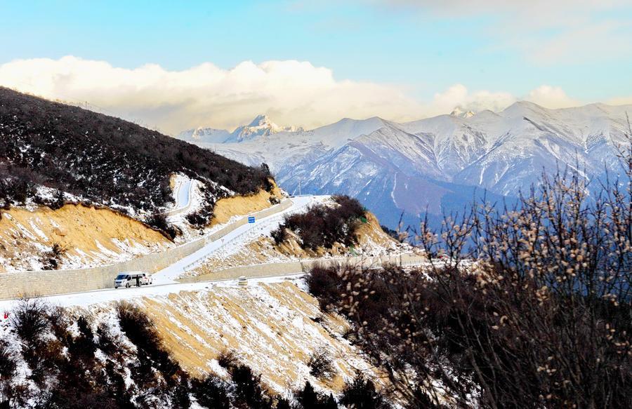 This photo taken on December 20, 2015 from the Sejila Mountain shows the winter scenery of the cloud-shrouded Namjagbarwa peak in Nyingchi, Tibet. The winter air in Nyingchi is fresh, with proper humidity, from the Sejila mountain pass which is at a latitude of 4728m, visitors can watch the stunning sunrise, as well as the mesmerizing view of the sea of clouds or forests. Although currently it is the slack season for tourism, there are still quite a number of visitors coming here to appreciate the unique scenery. Located at the Nyingchi prefecture in Tibet, Namjagbarwa, with an altitude of 7782m, is the fifteenth highest peak in the world. Since its giant triangular top is surrounded by mists and covered with snow all year long, the real appearance of the mountain is rarely seen, so it is nicknamed a "shy" mountain.[Photo/Xinhua]