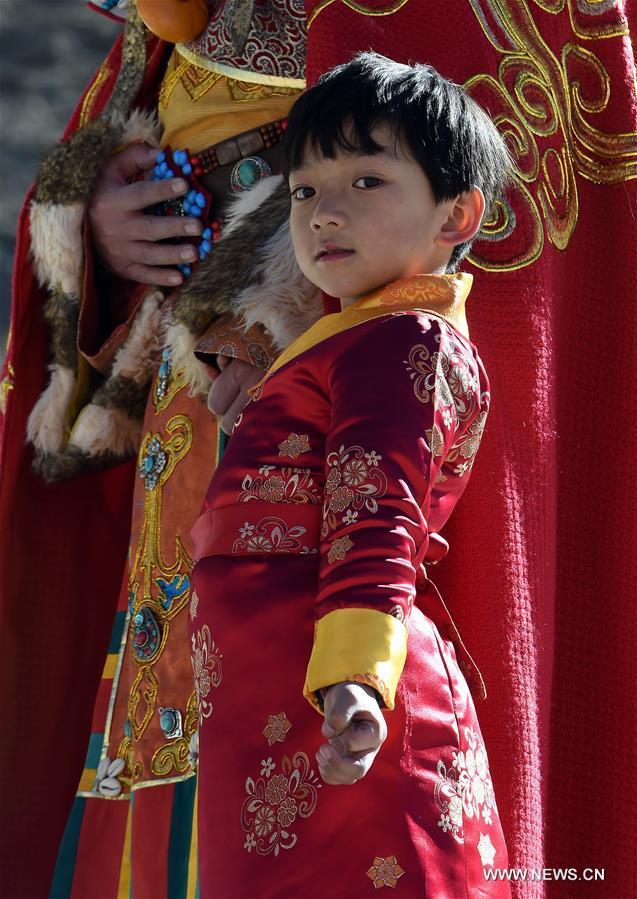 A young model presents a traditional Chinese costume, or Qipao, at a model show to celebrate the New Year