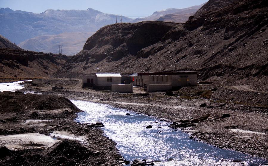 The morning sun is shining on the river, sparkling. Rinchen pea and zanba processing farmers