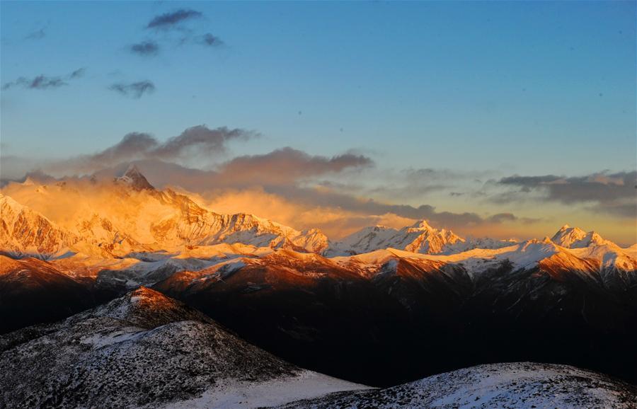 Photo taken on December 19, 2016 shows the scenery of Nnamjagbarwa Mountain  in the setting sun.With good climate and abundant natural resources, the air in Nyingchi is cool and refreshing in winter. Climbing upon the Segrila Pass at an altitude of 4,728 meters, you can have a beautiful view of sunrise, cloud sea and an immense forest. The Nnamjagbarwa Mountain is located in the Yarlung Tsangpo Grand Canyon, and is often described as China’s most beautiful mountain. Since Mt. Namjagbarwa is the holy mountain, no one can conquer its peak. Nnamjagbarwa Mountain is the highest mountain in Nyingchi, with an altitude of 7782 meters.