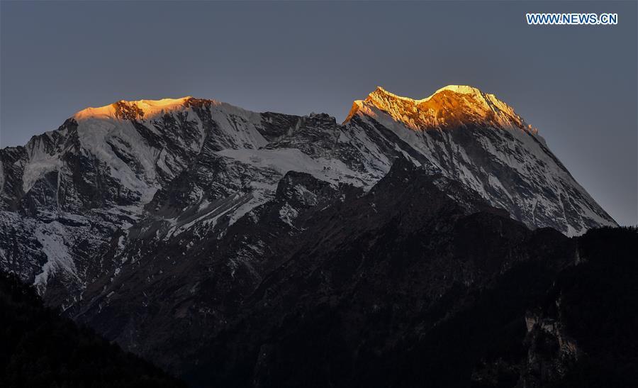 Sunshine casts on a snow mountains in Gyirong Township of Gyirong County, southwest China