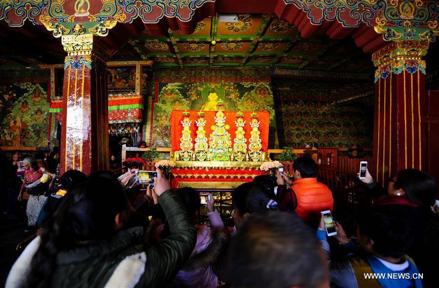 People visit an exhibition of butter sculptures made by Buddhists at Jokhang Temple in Lhasa, capital of southwest China