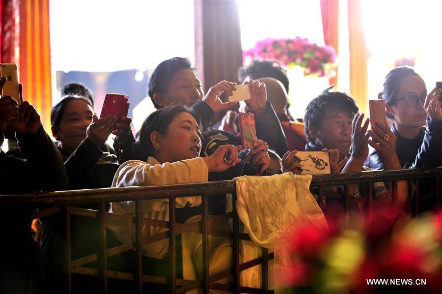 People visit an exhibition of butter sculptures made by Buddhists at Jokhang Temple in Lhasa, capital of southwest China